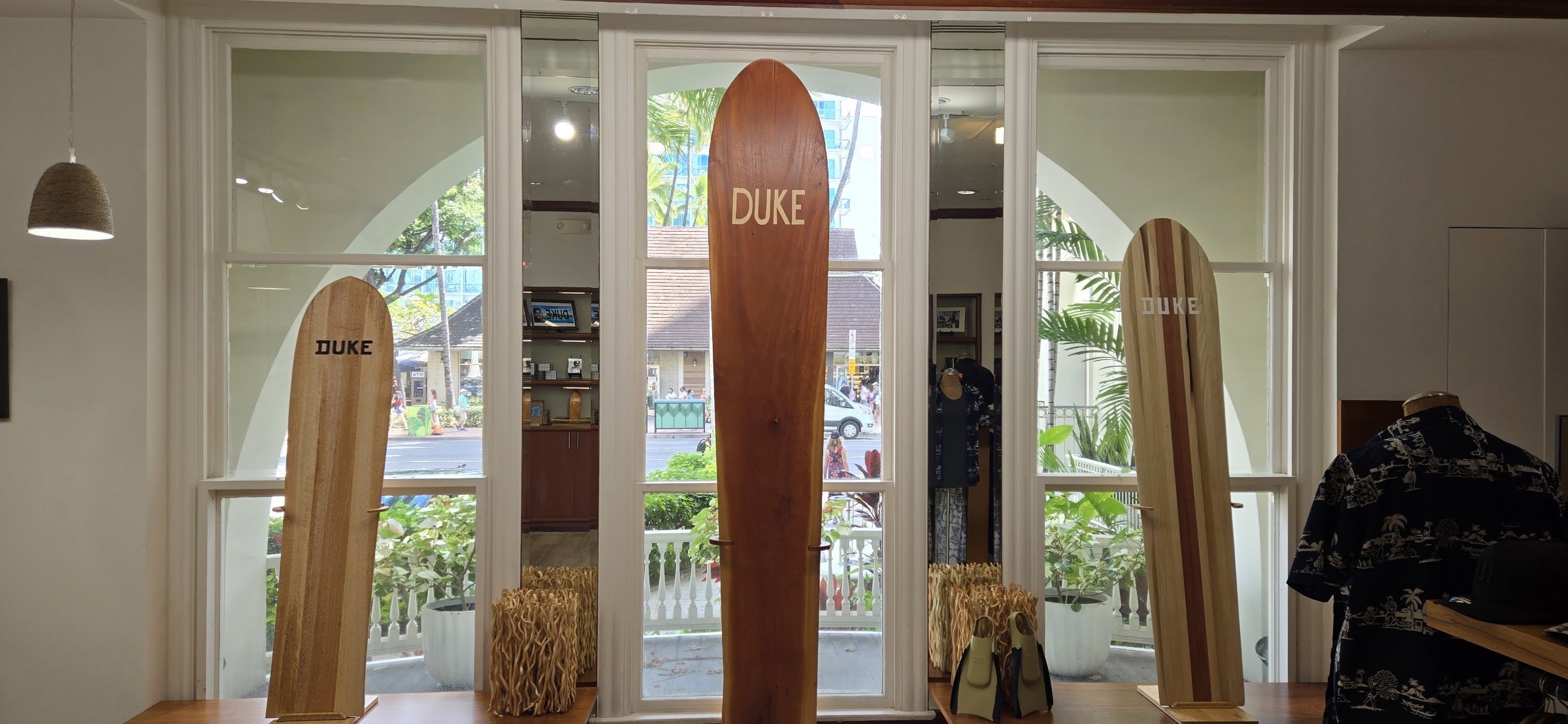 The window bay seen from inside the gallery, with wooden boards either side of a set of open arched doors.